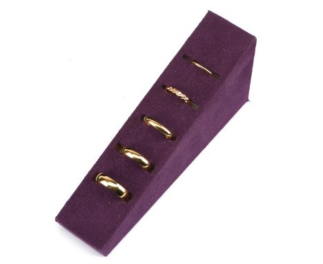 † A selection of five wedding bands, including a 1.8mm court wedding ring, size I, a 3.3mm wide woven wedding ring, size K, i