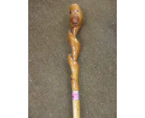 A tall carved walking stick with a duck's head handleProvenance: presented to the Chief Commissioner for England Scout Brigad