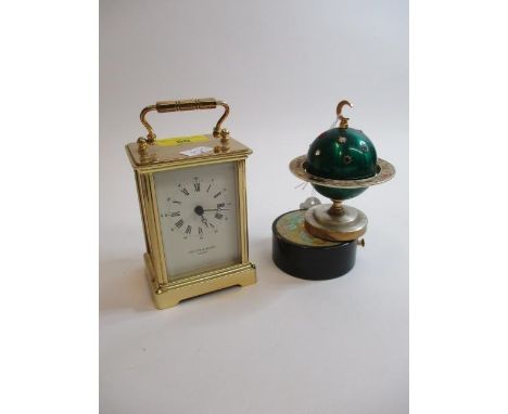 Taylor &amp; Bligh, London - a brass cased carriage clock and a musical lighter in the form of a globe 