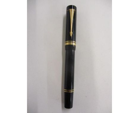 A Parker Duogold continental black fountain pen, the cap with an arrow clip and double cap band, the nib stamped 18K, 750 