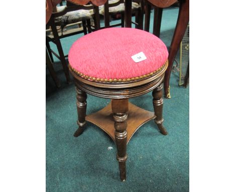 AN EDWARDIAN MAHOGANY STOOL the circular upholstered seat raised on turned legs joined by an under tier 53cm high