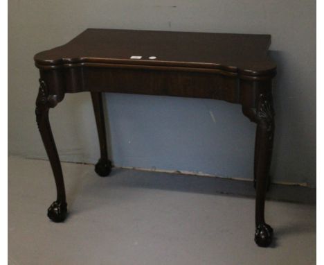 A FINE GEORGIAN STYLE MAHOGANY CARD TABLE of rectangular outline with eared corners the hinged lid containing a baize and too
