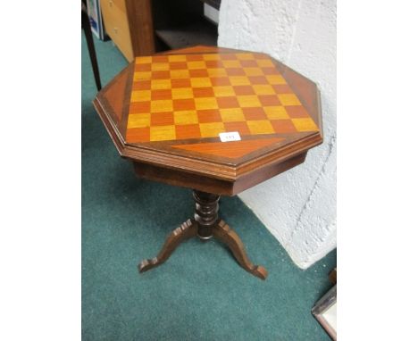 A BEECHWOOD GAMES TABLE of octagonal form with hinged lid raised on a baluster support and tripod base 77cm (h) x 53cm x 53cm