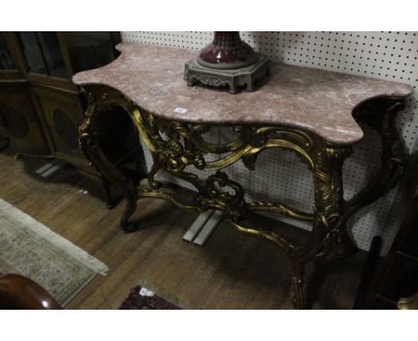 A CONTINENTAL GILTWOOD CONSOLE TABLE AND MIRROR the rectangular arched plate within a C scroll flowerhead and foliate moulded