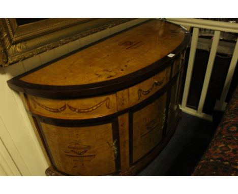 A GOOD WALNUT INLAID COMMODE of demi-lune outline the shaped moulded top above a frieze drawer and cupboards between moulded 
