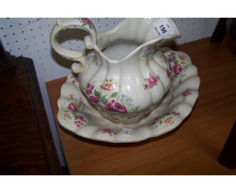 AN IRONSTONE STAFFORDSHIRE TWO PIECE JUG AND BASIN SET the white ground with floral decoration