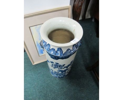 AN ORIENTAL STICK STAND the white and blue ground decorated with flowerheads and foliage with figural handles 56cm (h) x 23cm