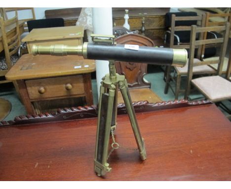 A BRASS AND LEATHER BOUND TABLE TOP TELESCOPE raised on telescopic tripod support telescope 43cm long