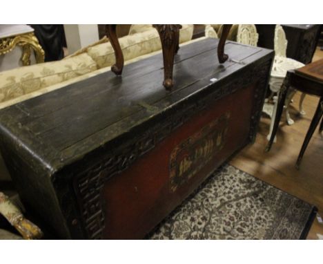 A CHINESE HARDWOOD AND POLYCHROME TRUNK of rectangular form the shaped moulded top with two lidded compartments above a pierc