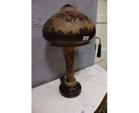 A CONTINENTAL PINK AND RUBY TABLE GLASS LAMP moulded in relief with flowerheads and foliage with mushroom shade and baluster 