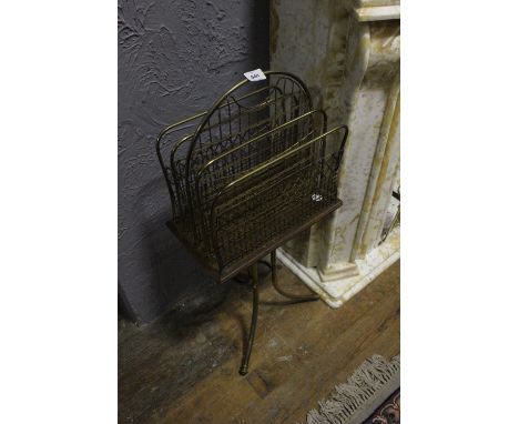 AN EDWARDIAN OAK AND BRASS MAGAZINE STAND on tripod support