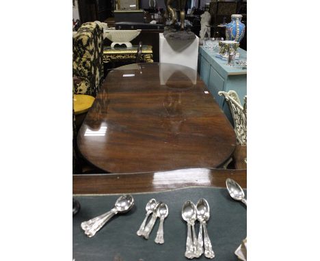 A REGENCY STYLE MAHOGANY D-END DINING TABLE of rectangular form with rounded ends and one loose leaf raised on twin tripod su