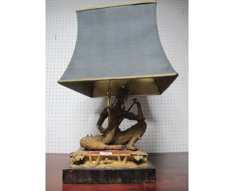 AN ORIENTAL FIGURAL TABLE LAMP with seated female with musical instrument raised on an ebonised base with shade 56cm (h) x 27