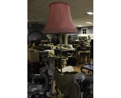 A VICTORIAN BRASS TELESCOPIC FLOOR STANDARD LAMP the cylindrical column raised on a pierced shaped platform with foliate and 