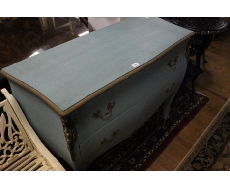 A CONTINENTAL BLUE PAINTED AND PARCEL GILT COMMODE of bombe outline the shaped moulded top above two frieze drawers between p