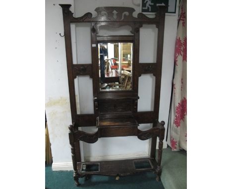 AN OAK HAT, COAT AND STICK STAND with rectangular bevelled glass mirror 202cm (h) x 106cm (w) x 30cm (d)