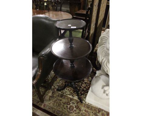 A GEORGIAN STYLE MAHOGANY THREE TIER DUMB WAITER c.1900 of circular dish outline each moulded shelf joined by a baluster supp