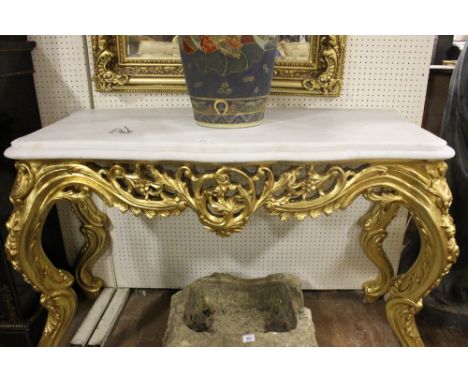 A FINE CONTINENTAL CARVED GILTWOOD CONSOLE TABLE of serpentine outline surmounted with a white vein marble top above a pierce