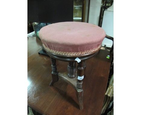 AN EDWARDIAN MAHOGANY STOOL the circular upholstered revolving seat raised on turned and reeded legs