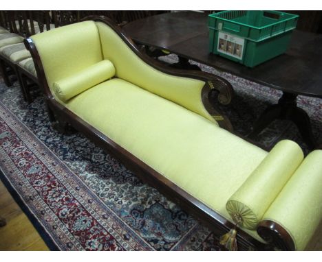A GOOD REGENCY STYLE MAHOGANY PARCEL GILT AND GILT BRASS MOUNTED CHAISE LONGUE the serpentine top rail with scroll finial abo
