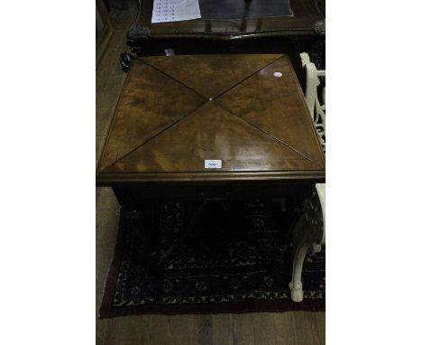 AN EDWARDIAN MAHOGANY ENVELOPE CARD TABLE the square moulded top with hinged leaves containing baize lined interior and count