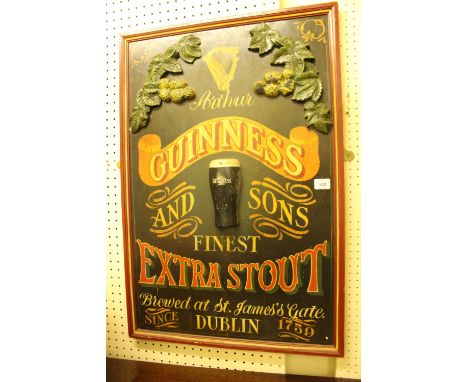 A PINE AND POLYCHROME GUINNESS ADVERTISING SIGN inscribed "Arthur Guinness and Sons Finest Extra Stout Brewed at St James Gat