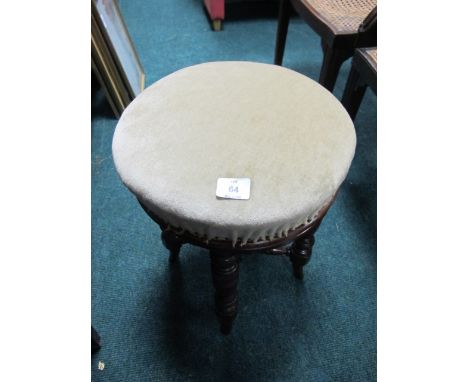 AN EDWARDIAN MAHOGANY AND UPHOLSTERED STOOL on turned legs