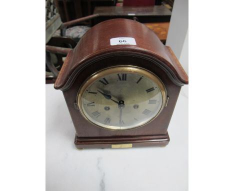 A MAHOGANY CASED MANTLE CLOCK the rectangular arched case with silver dial and Roman numerals raised on brass bun feet 28cm h