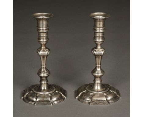 * Candlesticks. A pair of 18th century silver candlesticks, the marks visible but obscured, probably Barth Mosse, Dublin eith