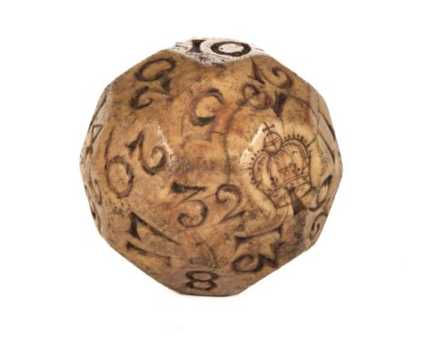 * Gambling ball. A rare 17th century ivory teetotum, English, multifaceted spherical ivory ball, one facet etched with a crow