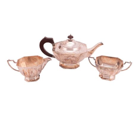 An Indian three-piece white metal tea service of Art Deco design, marked 'WB SIL', comprising teapot with bakelite mounts, 15