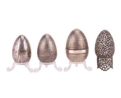 Stuart Devlin: four silver eggs of varying design, the largest London 1985, opening to reveal a sailfish, 7 cm high, the seco