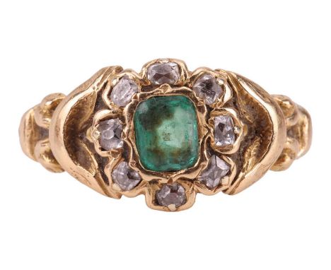 An emerald and diamond cluster ring, comprising a central collet-set step-cut emerald of vivid green colour, measuring approx