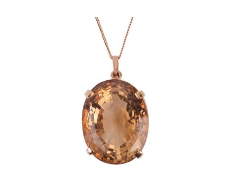 A citrine pendant, featuring an oval mixed-cut citrine of approximately 3.0cm x 2.4cm x 2.1cm, claw-set in yellow metal to a 