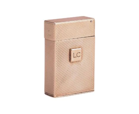Cartier - a 9ct gold lighter, of upright rectangular form with diagonal stripes, one side with a square slide action button t