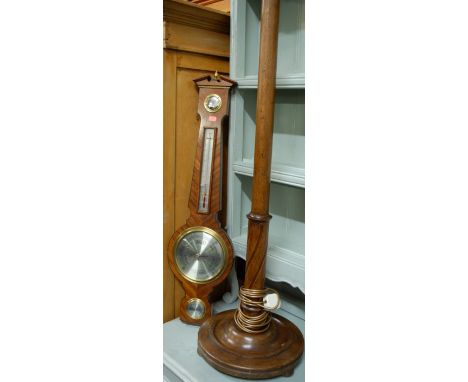 A 1920s turned oak standard lamp; together with a reproduction mahogany wheel barometer (2)
