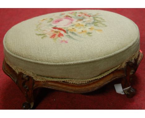 A Victorian rosewood and floral tapestry upholstered oval low footstool, width 38.5cm