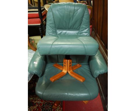 A Danish Unico formed laminate framed and leather upholstered swivel reclining armchair, with matching footstool (2). Some li