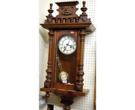 A late 19th century Continental walnut cased wall clock, having enamel dial with Roman numerals and eight day movement, heigh