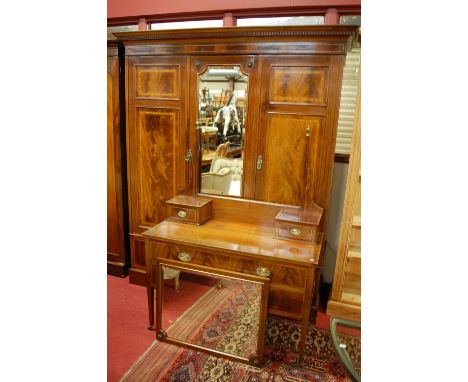 A good late Victorian mahogany, flame mahogany, satinwood crossbanded, and further strung triple wardrobe, having central bev