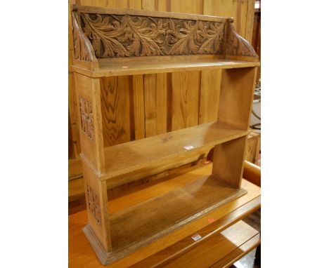 A 1930s relief carved oak three-tier hanging wall shelf, width 72.5cm