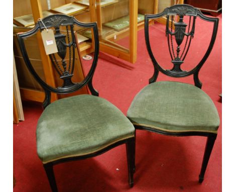 A set of four circa 1900 ebonised Sheraton Revival dining chairs, each having green upholstered stuff over seats, together wi