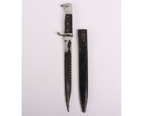 Pre-WW2 German Parade Bayonet with Sawback Blade, with two piece chequered grips, plated pommel and cross guard. Housed in it