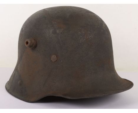 WW1 German M-17 Steel Combat Helmet, a well worn example of a M-16 helmet shell which appears to have just remains of a camou