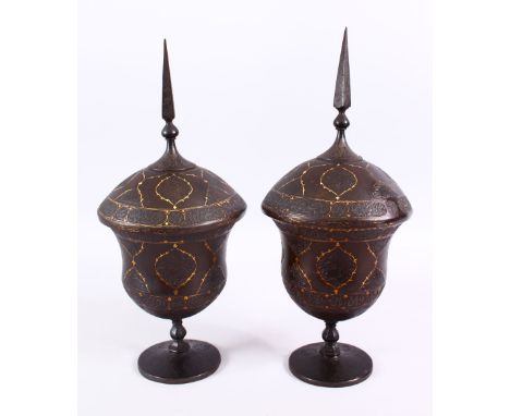 A FINE PAIR OF 19TH CENTURY PERSIAN QAJAR GOLD INLAID STEEL LIDDED URNS, with gold inlaid borders to panels of carved flora a