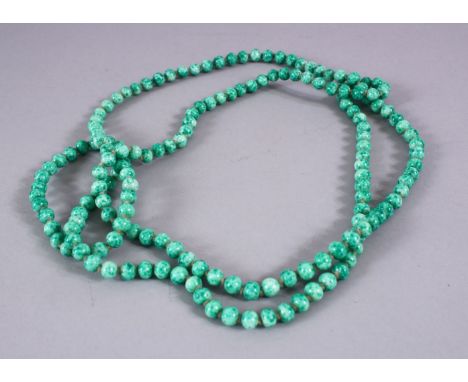 A CHINESE CARVED APPLE GREEN JADE LIKE NECKLACE, 118cm approx. open.