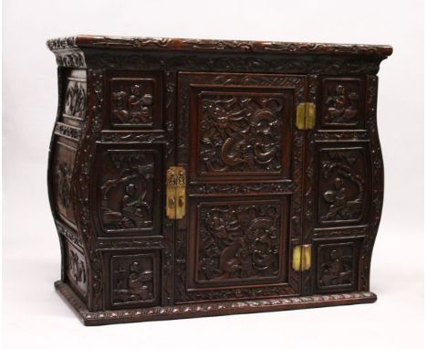 A GOOD 19TH CENTURY CHINESE CARVED HARDWOOD / HONGMU CABINET ON STAND, the cabinet with an opening door revealing a shelf, th