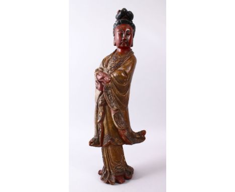 A LARGE 19TH CENTURY CHINESE CARVED AND LACQUERED WOODEN FIGURE OF GUANYIN, with carved wave decoration, stood holding a scro