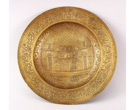 A 19TH CENTURY PERSIAN ENGRAVED CALLIGRAPHIC BRASS DISH, with bands of calligraphy and temple scenes, 22.5cm diameter.
