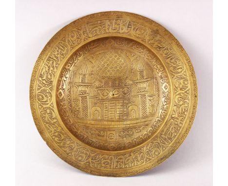 A 19TH CENTURY PERSIAN ENGRAVED CALLIGRAPHIC BRASS DISH, with bands of calligraphy and temple scenes, 22.5cm diameter.